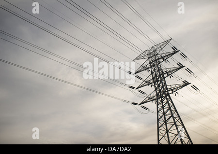 Power lines against an overcast grey and cloudy sky Stock Photo