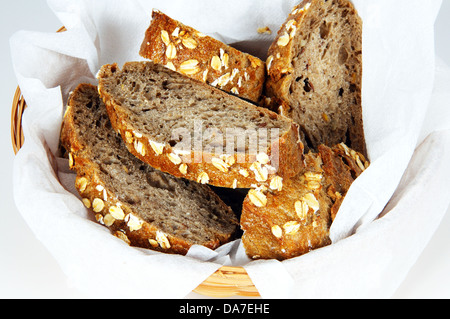 Sliced Kornspitz bread (German multigrain) in a wicker basket. Stock Photo