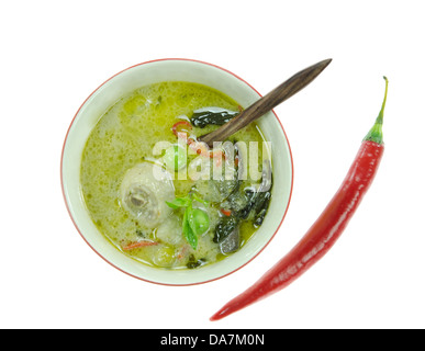 top view green chicken curry in bow with wooden spoon red chili on white Stock Photo