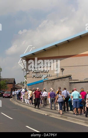 York, UK. 6th July, 2013. Railway enthusiasts and people just generally interested queing for up to a hour to enter the UK National Railway Museum  in York to see the A4 Gresley Pacific steam engine 'Mallard' at the 'Mallard 75' event. Mallard set the world record for a steam train at 126mph on July 3rd 1938. She has been joined at York for 'The Great Gathering' with all six surviving A4 Pacifics on display together. Recent concerns about cuts in future funding for this and other UK science museums have led to speculation about possible closure of one or more. Credit:  Joseph Clemson/Alamy Liv Stock Photo