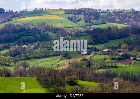 Bucolic scenic landscape with hilly pastures and farmhouses in Midi-Pyrenees region of France Stock Photo