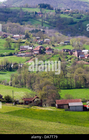 Bucolic scenic landscape with hilly pastures and farmhouses in Midi-Pyrenees region of France Stock Photo