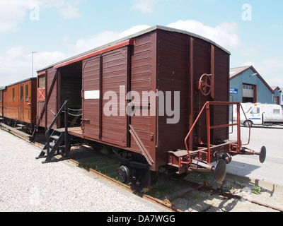 This image features a Danish railroad car from the Mariager-Handest Veteranjernbane, a historical railway system. The photograph highlights the design of the vintage railcar, emphasizing its role in Denmark's railway heritage. Stock Photo