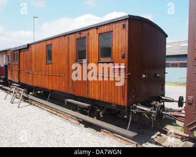 This image features a Danish railroad car from the Mariager-Handest Veteranjernbane, a heritage railway. The car is part of the preserved rolling stock used for historical railway tours, showcasing Denmark’s railway history. Stock Photo