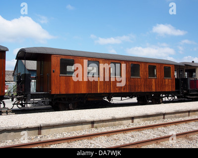 This historical image of the Mariager-Handest Veteranjernbane shows a Danish railroad car from the vintage era. The railcar, part of a heritage railway, exemplifies early 20th-century Danish rail travel and the preservation of historic railway transport. Stock Photo