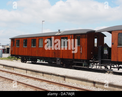 This photograph features a vintage Danish railroad car from the Mariager-Handest Veteranjernbane. The line is known for its preserved steam trains, and the image captures the elegance of the historical railcar as part of Denmark's rich railway heritage. Stock Photo