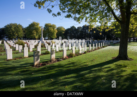 Graves and a Maple tree at the Bény-sur-Mer Canadian War Cemetery Stock Photo