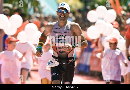 Frankfurt Main, Germany. 07th July, 2013. Eneko Llanos from Spain wins the Ironman in Frankfurt Main, Germany, 07 July 2013. The participants from 55 countries had to swim 3.8 km, cycle 180 km and run 42.195 km. Thousands of spectators attended the event. Photo: BORIS ROESSLER/dpa/Alamy Live News Stock Photo