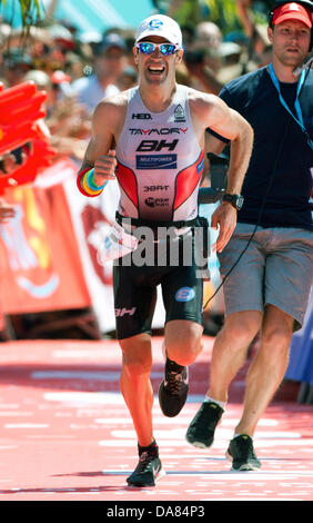 Frankfurt Main, Germany. 07th July, 2013. Eneko Llanos from Spain wins the Ironman in Frankfurt Main, Germany, 07 July 2013. The participants from 55 countries had to swim 3.8 km, cycle 180 km and run 42.195 km. Thousands of spectators attended the event. Photo: BORIS ROESSLER/dpa/Alamy Live News Stock Photo