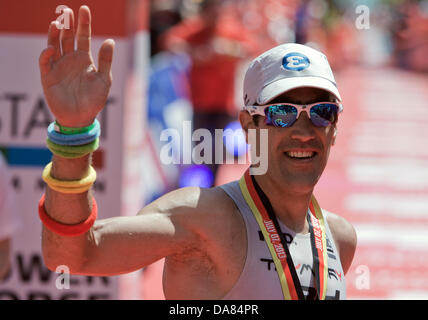 Frankfurt Main, Germany. 07th July, 2013. Eneko Llanos from Spain wins the Ironman in Frankfurt Main, Germany, 07 July 2013. The participants from 55 countries had to swim 3.8 km, cycle 180 km and run 42.195 km. Thousands of spectators attended the event. Photo: BORIS ROESSLER/dpa/Alamy Live News Stock Photo