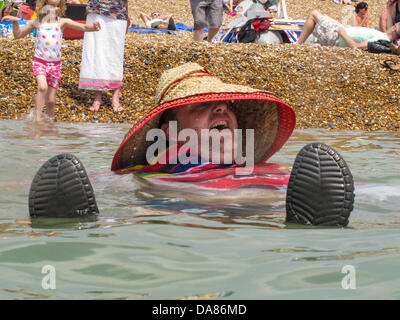 Brighton, UK. 07th July, 2013. Contestants in 'Paddle something Unusual' have fun both on and off there curious craft at  Paddle Round the Pier Beach Festival, Brighton, 7th July 2013 photo ©Julia Claxton Credit:  Julia Claxton/Alamy Live News Stock Photo