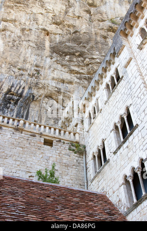 Stone walls of historic Basilica of St-Sauveur blend into the cliff in Rocamadour, France Stock Photo