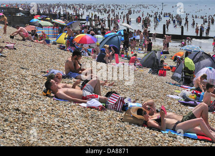 West Wittering, West Sussex, UK. 7th July, 2013. Sizzling Sunday as day-trippers take to the popular West Wittering beach to cool off as the temperatures rose to 30 degrees inland in southern England  2nd car park opened to accommodate up to 10.000 cars. iPhones and  iPads were at the ready to stream the Wimbledon tennis in  beach tents  and under umbrellas Credit:  Gary Blake/Alamy Live News Stock Photo