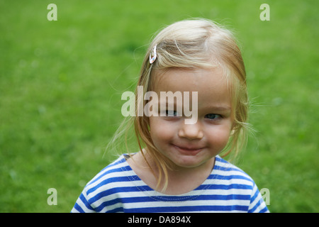 Portrait of child blond smiling girl outside Stock Photo