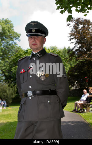 1940, 1941, 1942, 1943, 1944, German soldier at Ingleton, UK. 7th July, 2013. Reenactor dressed as German Hauptsturmführer a Nazi party officer of paramilitary rank. Historical reenactment with German soldiers at Operation Home Guard, Ingleton’s 1940’s weekend when Ingleton became the German occupied French market town of La Chapell-De-Marais liberated by re-enactors. Stock Photo