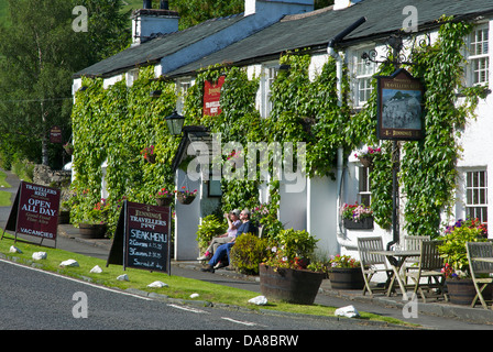 Couple sitting outside the Travellers Rest pub, near Grasmere, Lake District National Park, cumbria, England UK Stock Photo