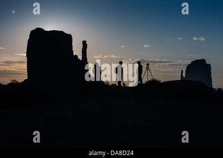 Silhouette of three photographers and tripods at the Mittens in Monument Valley Stock Photo