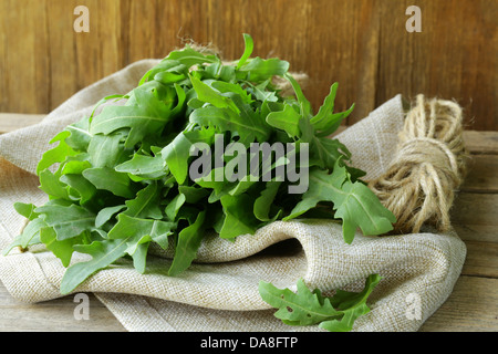 bunch of fresh green arugula on the wooden table Stock Photo