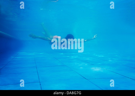 A woman swimming in a pool. Stock Photo