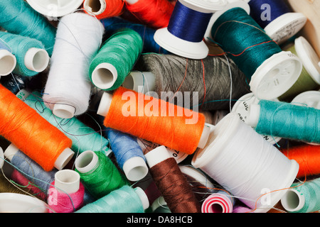 disorder in box with many spools of thread Stock Photo