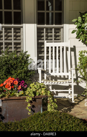 Rocking Chair and Flowers on Front Porch Stock Photo