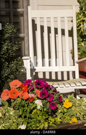 Rocking Chair and Flowers on Front Porch, NC, USA Stock Photo