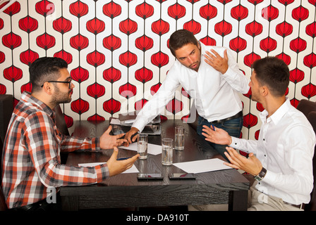 Business men having serious discussion at meeting in modern office Stock Photo