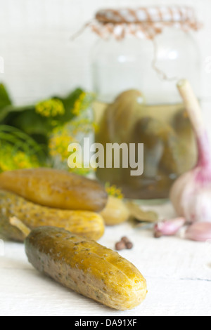 Pickles gherkins salted cucumbers still life on old planks Stock Photo