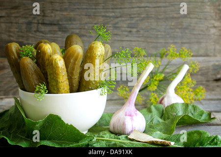 Pickles gherkins salted cucumbers still life on old planks Stock Photo