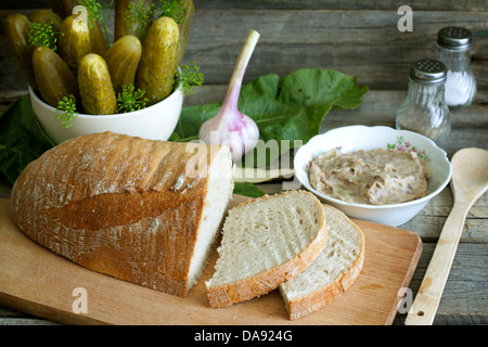 Bread lard and pickles on old vintage cutting board still life Stock Photo