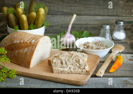 Bread lard and pickles on old vintage cutting board still life Stock Photo