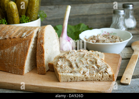 Bread lard and pickles on old vintage cutting board still life Stock Photo