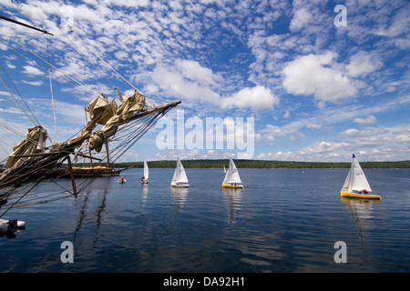 Wide angle landscape of mast and rigging of schooner in foreground and  sailboats in background at Tall Ship Festival, Shelburne,Nova Scotia, Canada Stock Photo