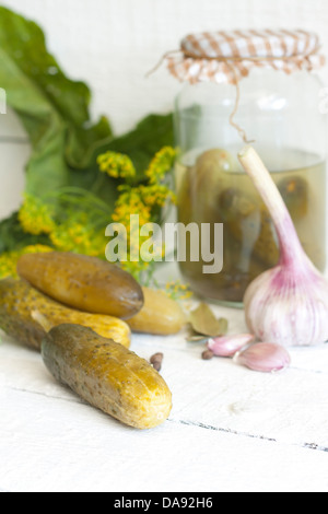 Pickles gherkins salted cucumbers still life on old planks Stock Photo