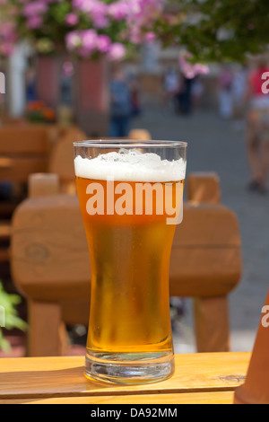 Glass of beer in restaurant on the table outdoor in the sun Stock Photo