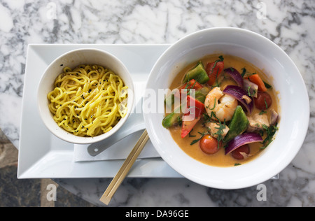 Prawn Thai Green Curry with egg noodles. Stock Photo