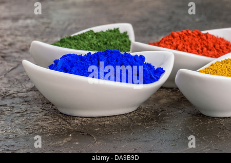 Vibrant color pigments in porcelain bowls Stock Photo