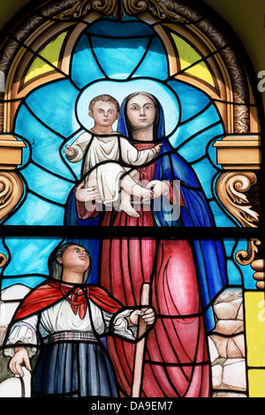 Virgin Mary holding baby Jesus nativity stained glass window in La Matriz church, Cotacachi, Ecuador Stock Photo