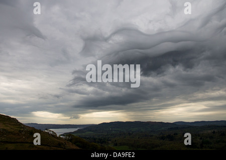 Grey stormy cloud formations over Esthwaite valley and Windermere as seen from Loughrigg fells. Stock Photo