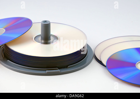CD-R data discs in a stack with several laid out on the desk Stock Photo
