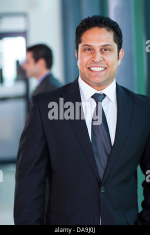 confident male Indian business executive in modern office Stock Photo