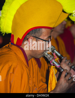 Paris, Fra-nce, Tibetan Monk in Traditional Costume Performing Music in Buddhist Ceremony, Pagoda Stock Photo