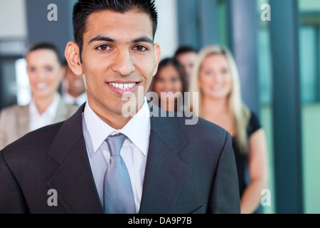 young middle eastern businessman with group of businesspeople on background Stock Photo
