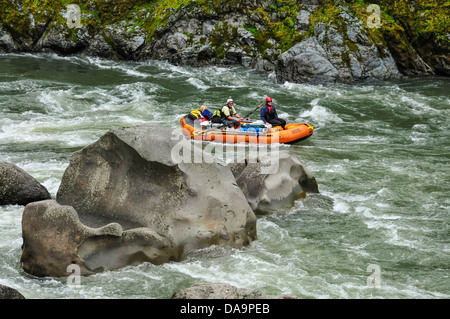 Tom and Alek rafting through the rapids at C Rock on the Wild and Scenic Rogue River in southern Oregon. Stock Photo
