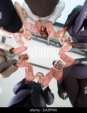 low angle view of business team hands together in circle Stock Photo