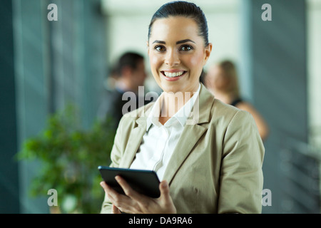 cheerful female entrepreneur using tablet computer in modern office Stock Photo