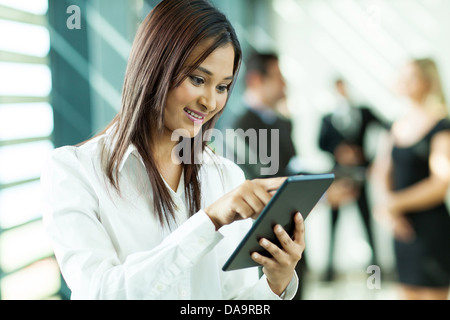 beautiful Indian white collar worker using tablet computer in office Stock Photo