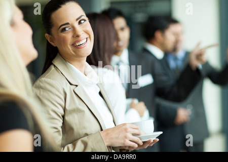 attractive businesswoman having fun conversation with colleague during break Stock Photo