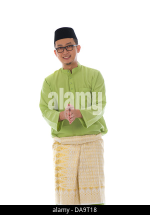 Malay male greetings during hari raya with isolated white background Stock Photo