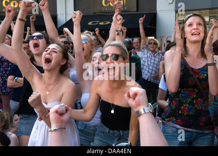 Watching sport Crowds cheering teen girl sports fans  HOMER SYKES Stock Photo